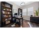 Stylish home office with built-in shelving, desk, and natural light at 2144 Bellcove Dr, Castle Pines, CO 80108