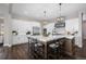 Bright kitchen features an island with bar seating, stainless steel appliances, and modern light fixtures at 2144 Bellcove Dr, Castle Pines, CO 80108