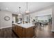 Large kitchen island with sink, complemented by stainless steel appliances and stylish pendant lighting at 2144 Bellcove Dr, Castle Pines, CO 80108