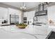 Spacious kitchen island with white countertop, stainless steel appliances and unique backsplash at 2144 Bellcove Dr, Castle Pines, CO 80108