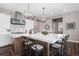 Bright kitchen showcasing a large island with seating and a modern backsplash at 2144 Bellcove Dr, Castle Pines, CO 80108