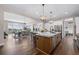 Open-concept kitchen with a large island, stainless steel appliances, and hardwood floors at 2144 Bellcove Dr, Castle Pines, CO 80108