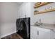 Well-organized laundry room with modern washer and dryer, ample counter space, and cabinet storage at 2144 Bellcove Dr, Castle Pines, CO 80108