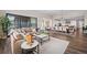 Open-concept living room with modern furnishings and access to an outdoor patio space at 2144 Bellcove Dr, Castle Pines, CO 80108