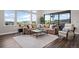 Bright living room features cozy seating, a marble coffee table, and large windows with a view at 2144 Bellcove Dr, Castle Pines, CO 80108