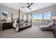 Bright main bedroom with a four-poster bed, neutral decor, and scenic views at 2144 Bellcove Dr, Castle Pines, CO 80108