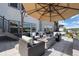Inviting outdoor space with lounge seating, a fire pit, and ample space for relaxation under the umbrella at 2144 Bellcove Dr, Castle Pines, CO 80108