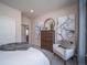 Bright bedroom with dresser, comfy chair, and calming wall art at 5190 N Quemoy Ct, Aurora, CO 80019