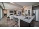 Modern kitchen island with seating and a view into the living room at 5190 N Quemoy Ct, Aurora, CO 80019