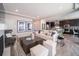 Spacious living room featuring a cozy fireplace and ample natural light at 5190 N Quemoy Ct, Aurora, CO 80019