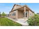 Charming home featuring a well-maintained lawn, covered porch, and beautiful outdoor space at 9781 Eagle River St, Littleton, CO 80125