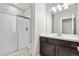 Bathroom features a glass-enclosed shower, a vanity with dark wood cabinets, and great lighting at 9781 Eagle River St, Littleton, CO 80125