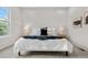 Well-lit bedroom with neutral tones features large bed, side tables, and ample natural light through a large window at 9781 Eagle River St, Littleton, CO 80125