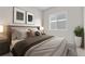 Cozy bedroom features natural light from the window, neutral paint, and stylish decor at 9781 Eagle River St, Littleton, CO 80125