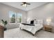 Well-lit bedroom features large windows, soft carpeting, and a modern, well-made queen-sized bed at 9781 Eagle River St, Littleton, CO 80125