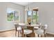 Bright dining room features a large window, slider door and a dining table that seats six at 9781 Eagle River St, Littleton, CO 80125