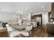 Open-concept layout reveals dining space and kitchen, complete with dining table with seating for six and island at 9781 Eagle River St, Littleton, CO 80125