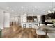 Spacious open-concept dining area and kitchen feature wood floors, and dining table with seating for six at 9781 Eagle River St, Littleton, CO 80125