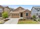 Charming single-Gathering home with a stone facade, a two-car garage, and a well-manicured lawn at 9781 Eagle River St, Littleton, CO 80125