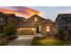 Charming single-Gathering home with a stone facade, a two-car garage, and a well-manicured lawn at 9781 Eagle River St, Littleton, CO 80125