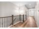 Bright hallway with hardwood floors, decorative railings, and ample natural light at 9781 Eagle River St, Littleton, CO 80125