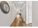 Inviting hallway featuring hardwood floors, neutral paint, leading to living spaces at 9781 Eagle River St, Littleton, CO 80125