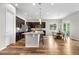 Modern kitchen featuring an island, hardwood floors, and an adjacent dining area at 9781 Eagle River St, Littleton, CO 80125