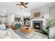 Cozy living room featuring a fireplace, with hardwood floors and a view into the kitchen at 9781 Eagle River St, Littleton, CO 80125