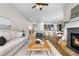 Cozy living room featuring a fireplace, with hardwood floors and a view into the kitchen at 9781 Eagle River St, Littleton, CO 80125