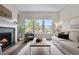 Living area featuring a fireplace and multiple windows offering ample natural light and views at 9781 Eagle River St, Littleton, CO 80125