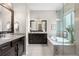 Large main bathroom featuring dark wood cabinets, granite counters, a soaking tub, and a glass shower at 9781 Eagle River St, Littleton, CO 80125