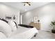 Bright main bedroom featuring neutral walls, plush carpet, modern art, and a light wood dresser at 9781 Eagle River St, Littleton, CO 80125
