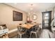 Dining room featuring a wooden table, modern chandelier, and conveniently located near a doorway at 327 S Xanadu St, Aurora, CO 80012