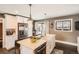 Bright kitchen with white cabinets, quartz countertops, stainless steel appliances, and a farmhouse sink at 327 S Xanadu St, Aurora, CO 80012