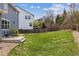 Wide backyard showing a lush green lawn, a patio set, and a privacy fence at 3475 Golden Spur Loop, Castle Rock, CO 80108