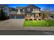 Charming two-story home with a manicured lawn, stone accents, and a two-car garage at 3475 Golden Spur Loop, Castle Rock, CO 80108