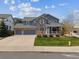 Charming two-story home with stone accents, three-car garage and inviting front porch at 3475 Golden Spur Loop, Castle Rock, CO 80108