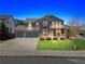 Charming two-story home with a well-manicured lawn, a welcoming front porch, and a two-car garage at 3475 Golden Spur Loop, Castle Rock, CO 80108