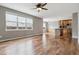 Open living room with wood floors connecting to the kitchen, and large window at 3475 Golden Spur Loop, Castle Rock, CO 80108