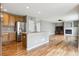 This kitchen with an island overlooks the living room with a fireplace at 3475 Golden Spur Loop, Castle Rock, CO 80108