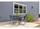 Outdoor patio area with a metal table and chair set next to a blue home at 3475 Golden Spur Loop, Castle Rock, CO 80108