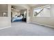 Large sitting area with plush gray carpet, neutral walls, and large sunny window at 3475 Golden Spur Loop, Castle Rock, CO 80108
