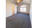 Bright bedroom with carpet and large window at 3802 Desert Willow Ave, Broomfield, CO 80020