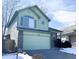 Light green two-story house with a two-car garage and snowy front yard at 3802 Desert Willow Ave, Broomfield, CO 80020