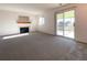 Living room with carpeting, a fireplace, and sliding glass doors to the patio at 3802 Desert Willow Ave, Broomfield, CO 80020