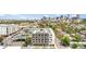Modern multi-story apartment building featuring solar panels on the roof with a city skyline in the distance at 603 Inca St # 530, Denver, CO 80204