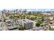 Modern multi-story apartment building featuring solar panels on the roof with a city skyline in the distance at 603 Inca St # 530, Denver, CO 80204