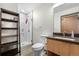 Modern bathroom features a glass-enclosed shower, dark-stained vanity and neutral finishes at 603 Inca St # 530, Denver, CO 80204