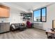 Well-lit living room featuring hardwood floors, a modern sofa, and a large window offering ample natural light at 603 Inca St # 530, Denver, CO 80204
