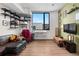 Comfortable living room with a sofa, desk, and window overlooking city buildings at 603 Inca St # 530, Denver, CO 80204